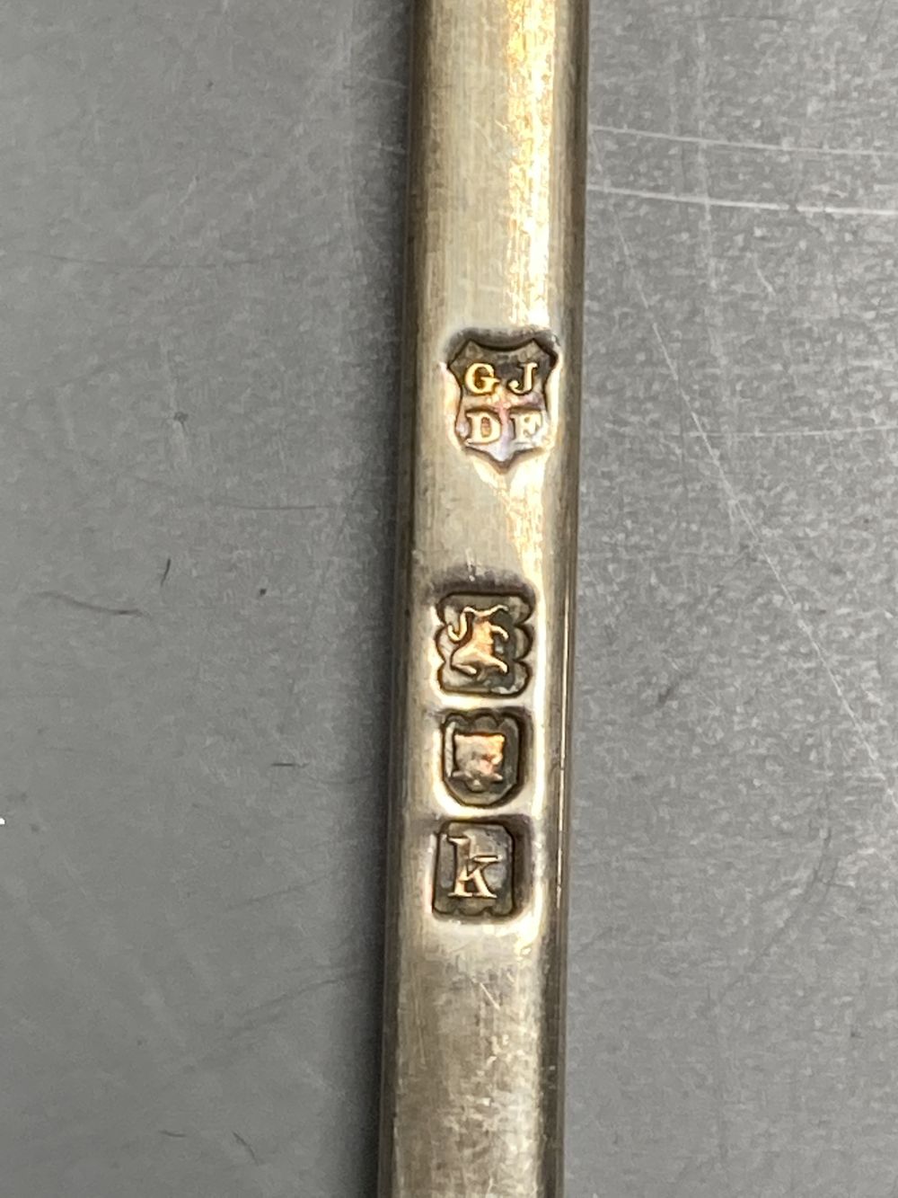 An Edwardian silver seal top spoon, London, 1905, 19.9cm and a pair of novelty plated spoons with figural handles.